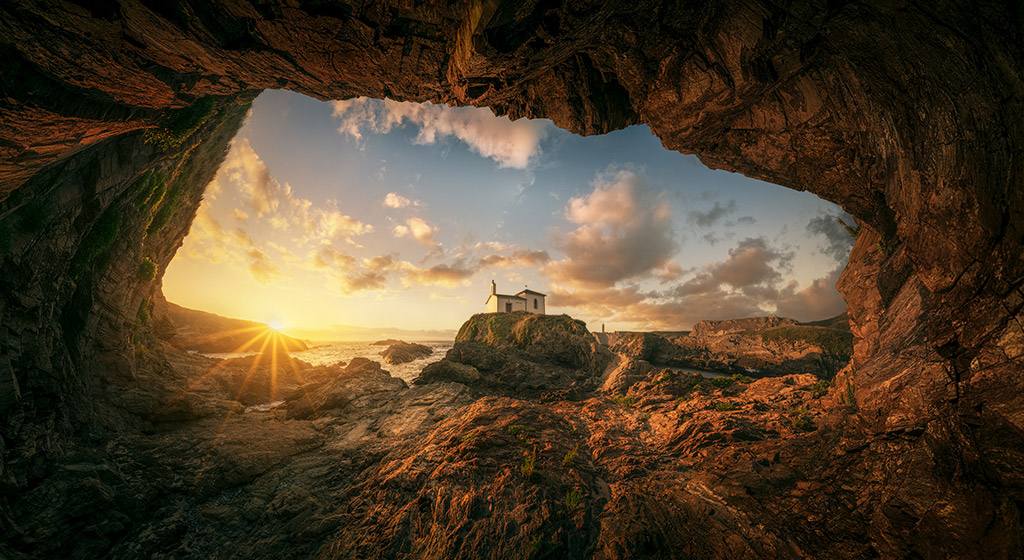 Sun setting behind the Virxe Do Porto in Valdoviño (Spain) by Daniel Viñé