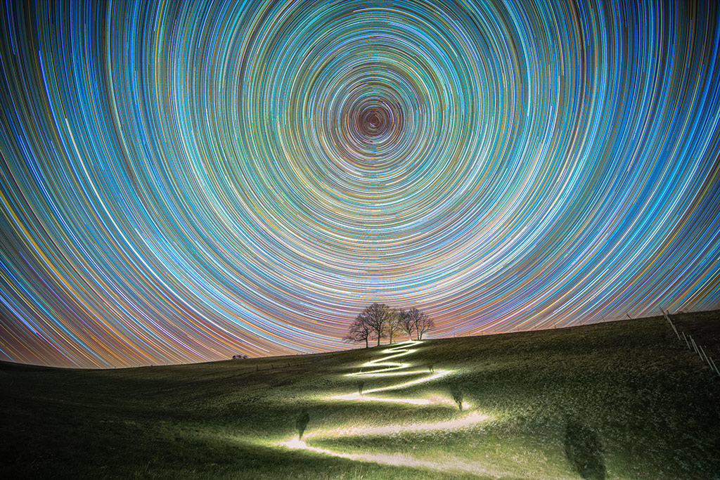 Circumpolar above some trees by Mario Konang