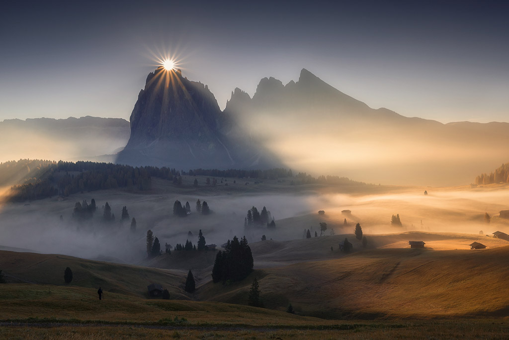 Sunburst behind the Sassolungo in the Dolomites (Italy) by Davide Donati